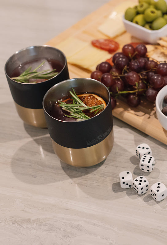 Black and gold tumbler with cocktails