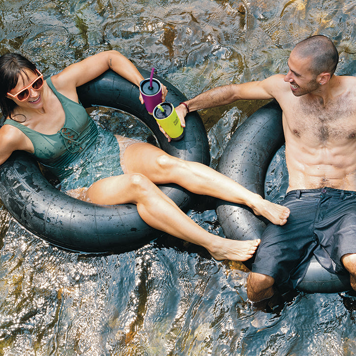 Couple in inflatable tubes using Klean Kanteen Tumblers and Straws